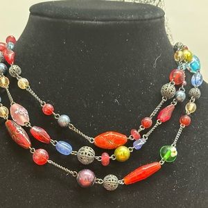 Gold tone necklace with different colored stones